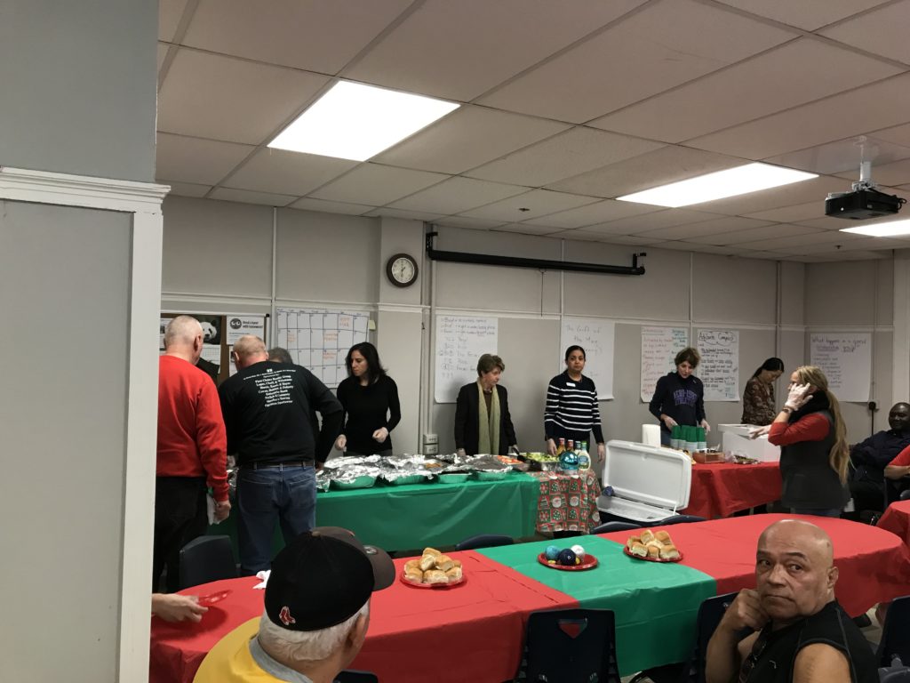 volunteers and board members serve a holiday meal to residents in the sro program.