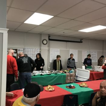 volunteers and board members serve a holiday meal to residents in the sro program.