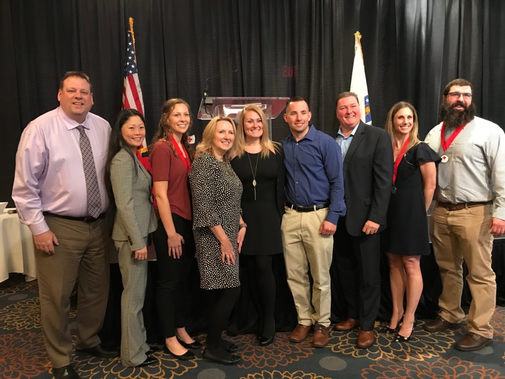 MVYMCA COO Frank Kenneally with American Red Cross of Massachusetts 2019 Heroes. Andover/North Andover Y Sr. Exec. Dir. Claudia Soo Hoo, lifeguard Mary Lavalee, Aquatics Dir. Dan Burke, and Membership Dir. Lindsey Lerit with Y member Stacie Logan. and her family